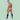 Male model smiling over shoulder while wearing minimal red thong from the Good Devil Thong for Men collection.